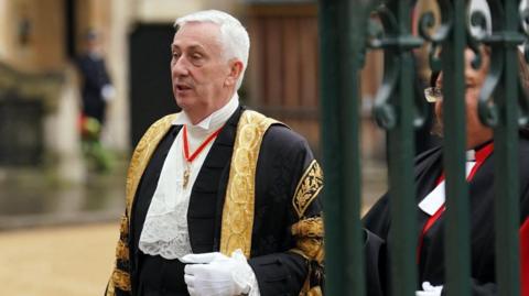 Sir Lindsay Hoyle in black and gold ceremonial robe with white frilled shirt