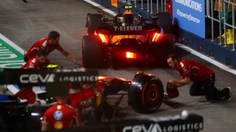 The aftermath of Ferrari's Charles Leclerc and McLaren's Lando Norris colliding in the pit lane