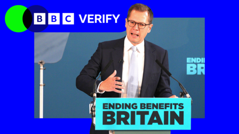 An image of MP Robert Jenrick while talking, wearing a suit and light blue tie, in a BBC Verify branded border.