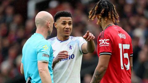 Ollie Watkins points at Leny Yoro during a Premier League tie