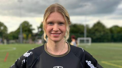 Billie Sky smiles in her football kit