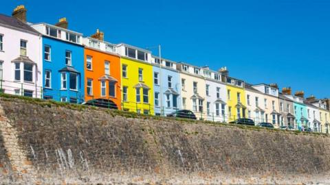 A row of colourful houses against a blue sky