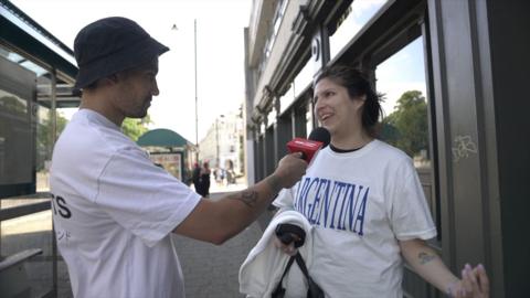 Reporter interviewing Oasis fan