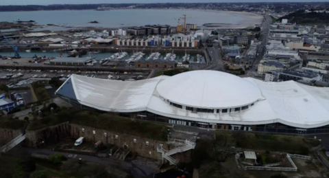Drone image of Fort Regent and the St Helier skyline, including views of St Aubin's Bay

