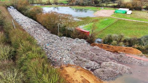 A huge pile of fly-tipped waste that was dumped in a field in Oxfordshire last year