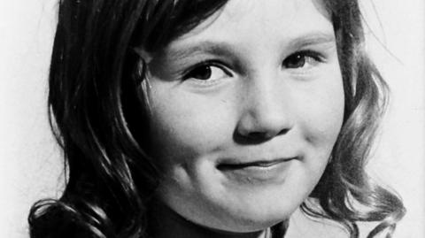 Black and white image of Julie Livingston who had wavy/curly shoulder length hair 