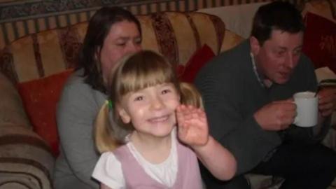 Cat Foster-Phillips with her parents when she was young