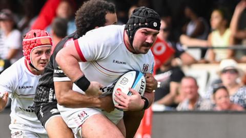 Tom O'Toole carries the ball against the Sharks