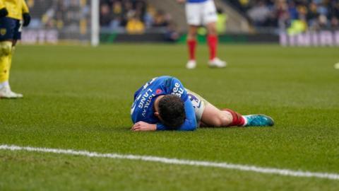 Portsmouth's Callum Lang on the grass during their match against Oxford United