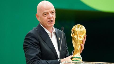 Gianni Infantino with the World Cup trophy at a pre-tournament news conference
