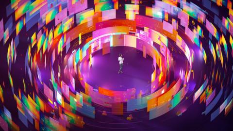 A person surrounded by countless virtual screens of many colours