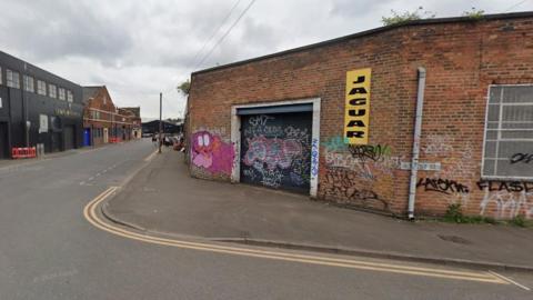 A road junction, with Bordesley Street on the left of the photo and Trent Street going from left to right on the generic image. There is graffiti on the wall at a corner where the two roads meet.