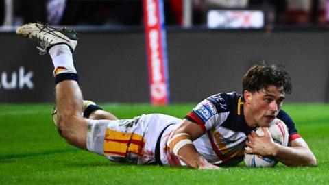 Catalans Dragons' Lewis Dodd diving over to score a try