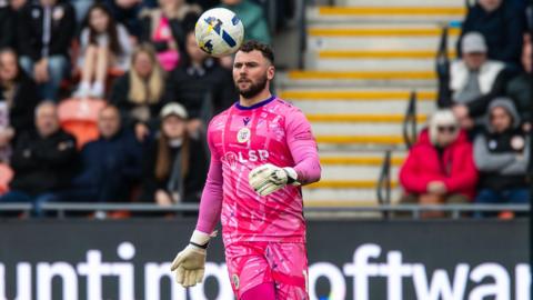Grant Smith looks as a ball bounces in the air in front of him while on the pitch during a match for Bromley