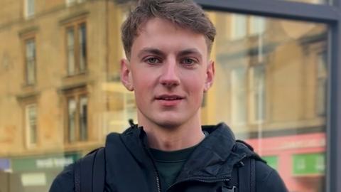 A young man looking at the camera