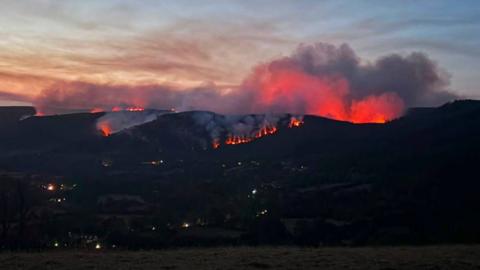 A night time scene of a large fire in Llandovery