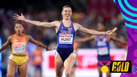 Amy Hunt celebrates with her arms stretched out as GB win relay gold