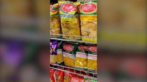 Packets of crisp like snacks on a shop shelf