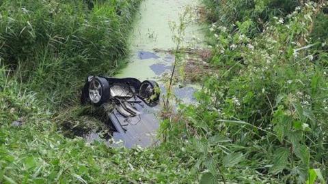 Car in fenland ditch