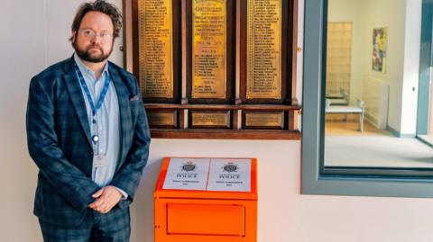 Cleveland Police and Crime Commissioner Matt Storey next to a knife surrender bin