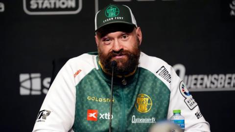 Tyson Fury bruised and cut in a news conference