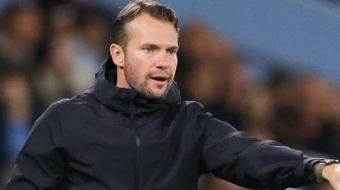 Tom Cleverley points and gives instructions from the touchline in a Watford game