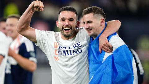 Scotland's John McGinn and Kenny McLean celebrate after qualifying for the 2026 World Cup after beating Denmark 4-2 in their final qualifier at Hampden Park, Glasgow. 