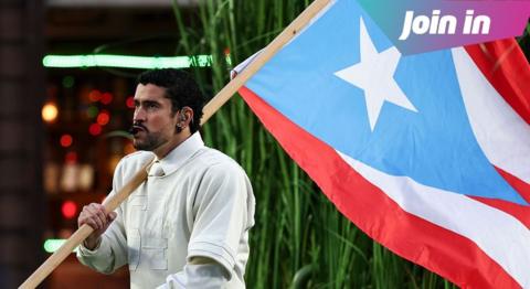 Bad Bunny holding a Puerto Rico flag.