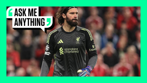 Alisson during a match - the crowd is out of focus in the background and the image has a green border with 'Ask Me Anything' in the top corner