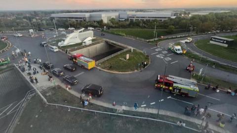 A aerial view of roads, showing two fire engines arriving