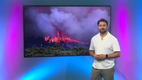 Ricky next to a plasma showing an image of fire