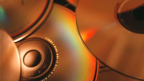 The back of several CD that are spread out.