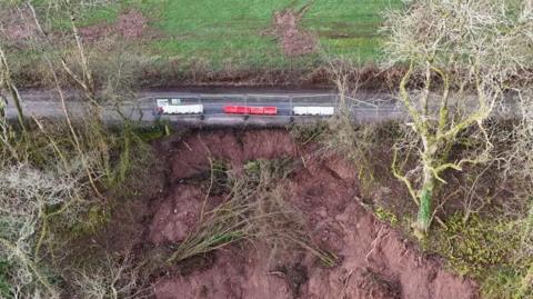 Drone shows the scale of the landslip in relation to the closed off road