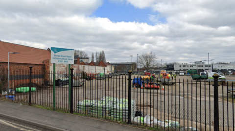 A Google Street view of the Stores Road Depot showing vehicles and workers on the site
