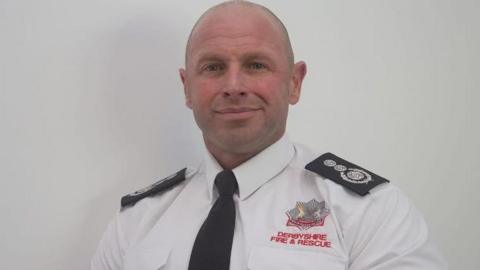 A man in a fire officer's uniform