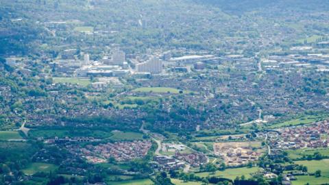 A view from a plane over Bracknell on a sunny spring afternoon. The stepped tower block Royal Winchester House is at the centre of the image with new developments surrounding it.