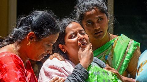 Family members of a victim who died during the stampede outside the M. Chinnaswamy Stadium grieve in front of her body at their residence in the Yelahanka locality in Bengaluru on June 5, 2025. Virat Kohli said he was lost for words after celebrations of a dream IPL title turned to tragedy when 11 mainly young cricket fans were crushed to death in Bengaluru. Hundreds of thousands had packed the streets on June 4 to welcome home their hero Kohli and the Royal Challengers Bengaluru (RCB) after they had beaten Punjab Kings a day earlier in a thrilling Indian Premier League final. (Photo by AFP) (Photo by -/AFP via Getty Images)