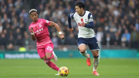 Omari Hutchinson chases Son Heung-min on the ball