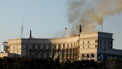 Smoke rises over a headquarters building of the Ukrainian government.