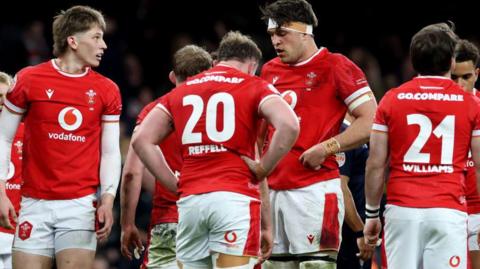 Wales players are dejected after the defeat against England