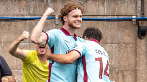 Zack Clarke is congratulated by Noah Edwards after scoring Caernarfon's winner