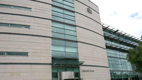 Laganside Courthouse which has white brickwork and glass panels. 