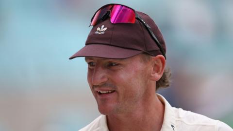 Nathan Smith wearing a Surrey brown cap
