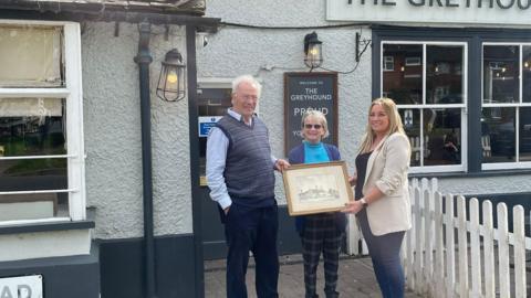 John Marrack with Rachael Howlett handing over the painting