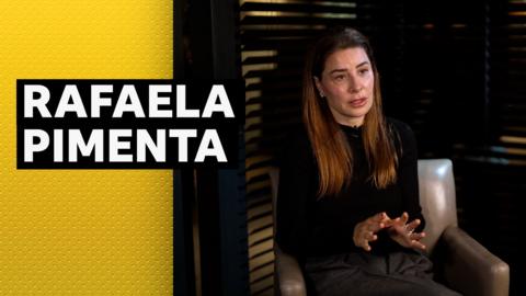 Football agent Rafaela Pimenta sitting in a chair mid interview