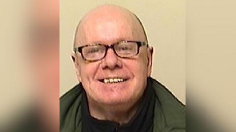 Vincent Lee is pictured wearing glasses against a beige background