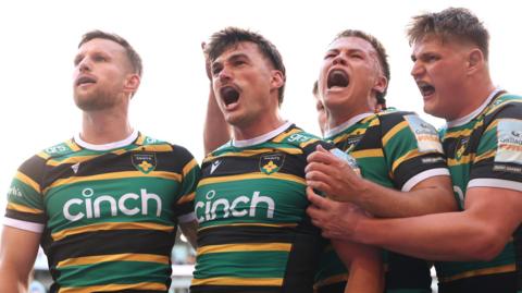 George Furbank (centre) celebrates scoring a try for Northampton against Leicester in the Prem semi-final
