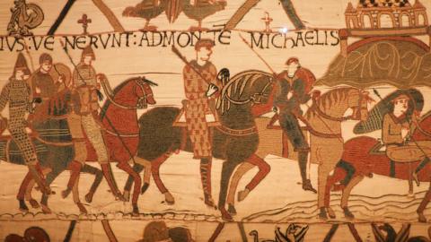 A detail from the Bayeux Tapestry showing several figures on horeeback