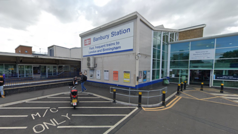 The entrance to Banbury Railway Station, a perpendicular building with glass windows