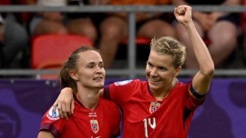 Norway's forward #10 Caroline Graham celebrates after scoring a goal with teammate Norway's forward #14 Ada Hegerberg